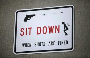 Sit-Down-When-Shots-Are-Fired-Prison-Sign.jpg